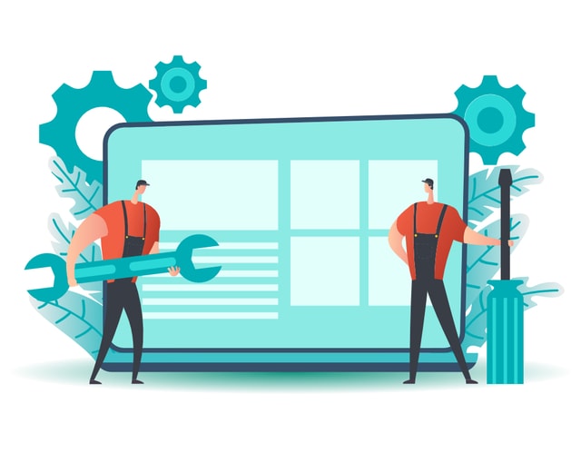 Two construction workers, one holding a screwdriver and another holding a wrench standing in-front of a laptop they are doing maintenance on.