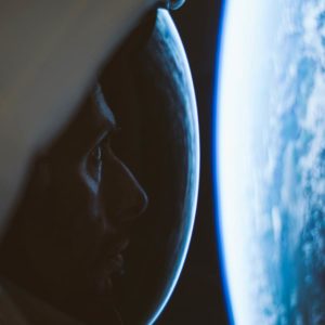 Astronaut in space looking at a planet.